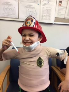 Burn Foundation-kid with fire hat at Harborview