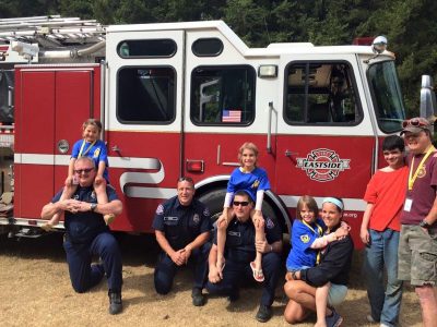 Camp-Eyabsut kids with firefighters in front of Eastside's truck