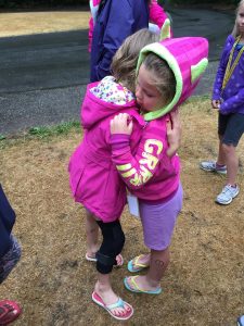 Camp-Eyabsut girls in pink hugging